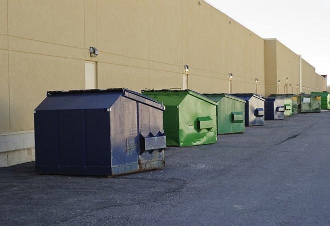 construction dumpsters stacked in a row on a job site in Clayton